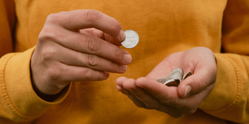 Person counting coins featured image