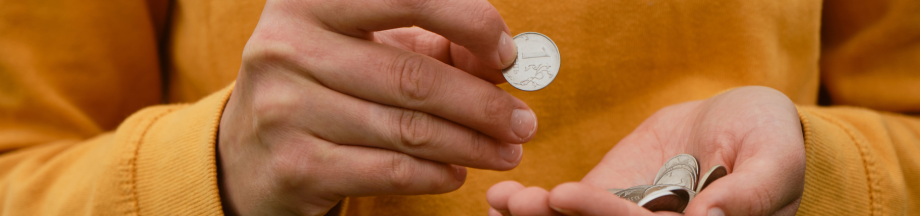 person holding coin top banner