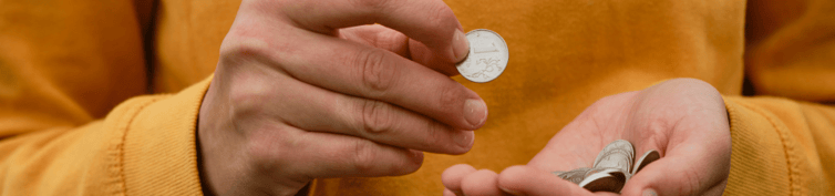 person holding coin top banner