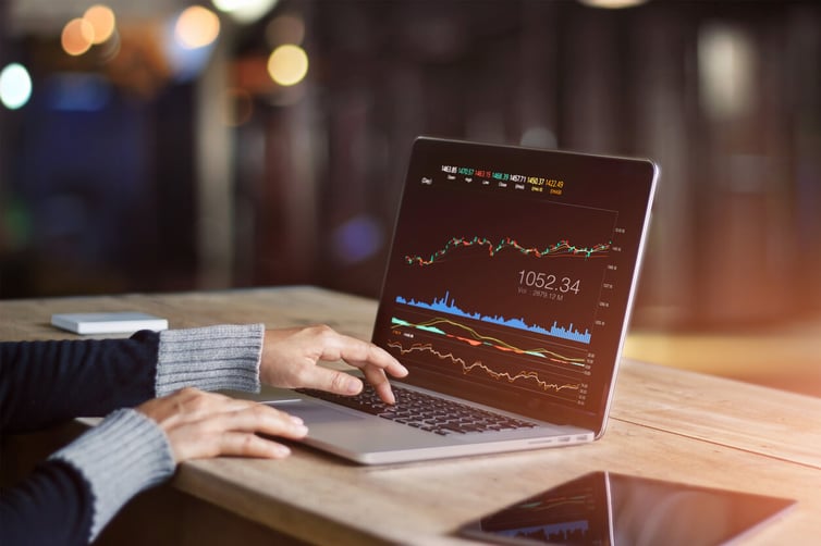 man on laptop checking global market 