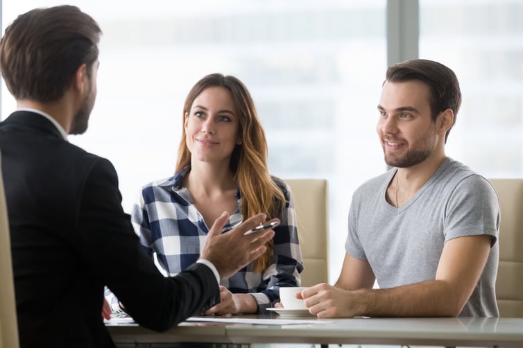 young couple talking to a financial advisor