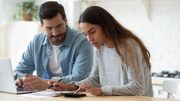 Photos  Search by image Young husband and wife using calculator laptop talking doing paperwork stock