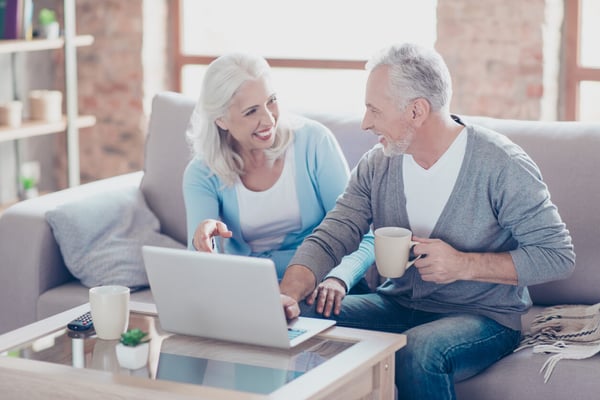 Two elderly people are sitting at home